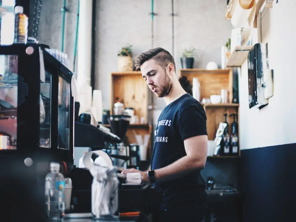 New York City minimum wage employee in a coffee shop
